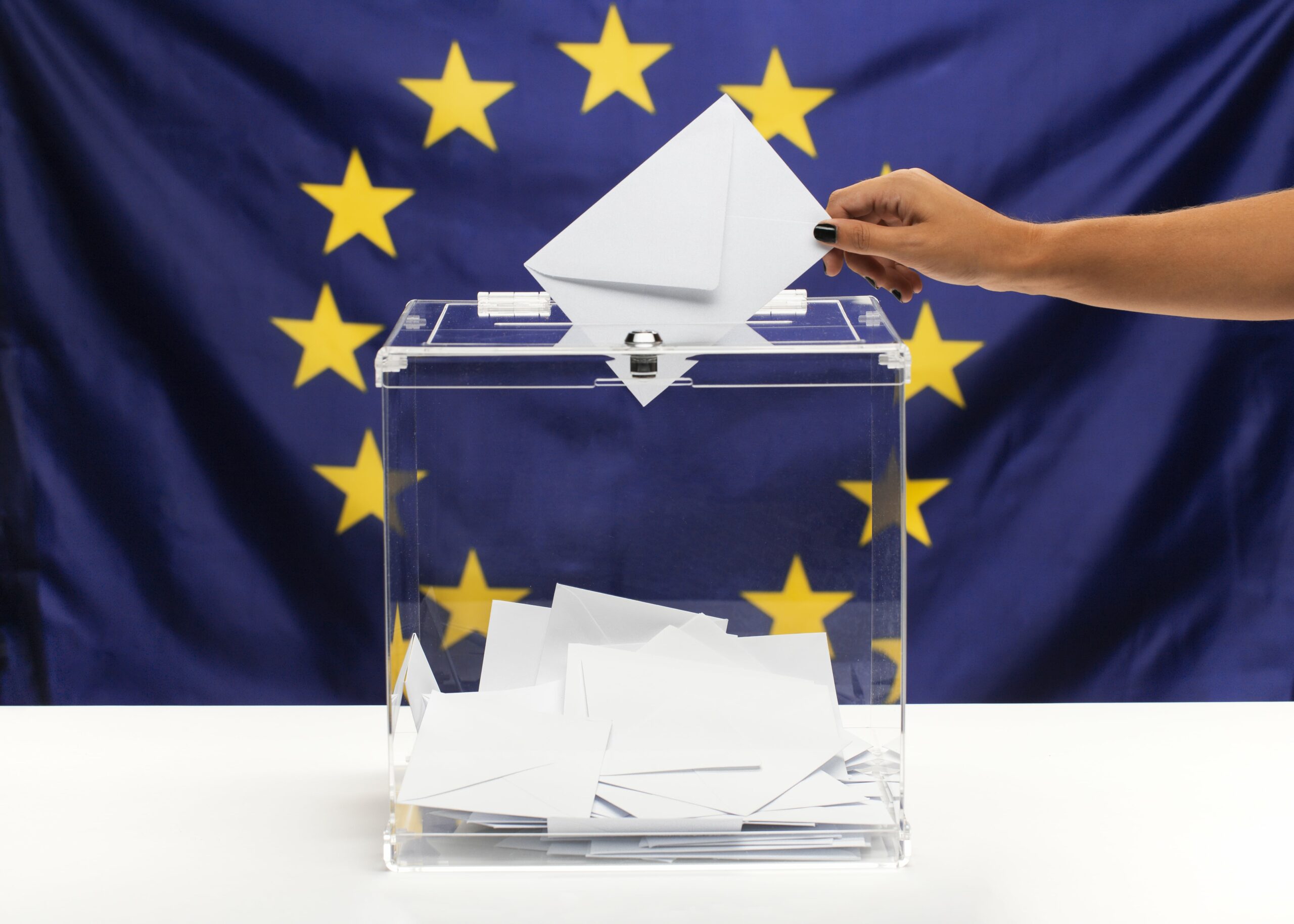 transparent ballot box filled with white envelope european union flag front view min